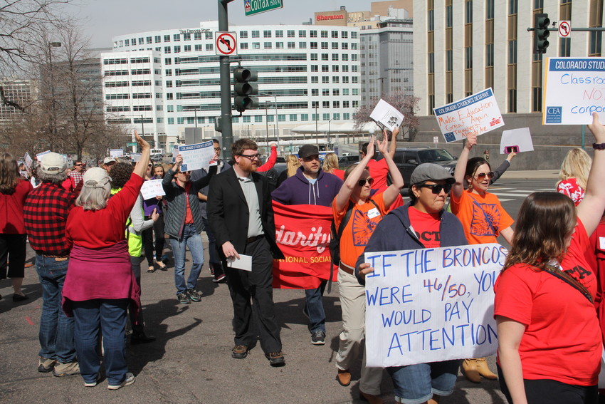 Teachers and other educators march on the April 16 “Day of Action,” where about 400 protested some changes to the state’s public-pension system and advocated for more school funding at the Capitol. The sign at bottom right references a 2016 ranking of Colorado’s average teacher pay as 46th in the nation by the National Education Association. That figure was revised in updated NEA rankings to 31st in average teacher pay in 2017 and 30th in 2016.